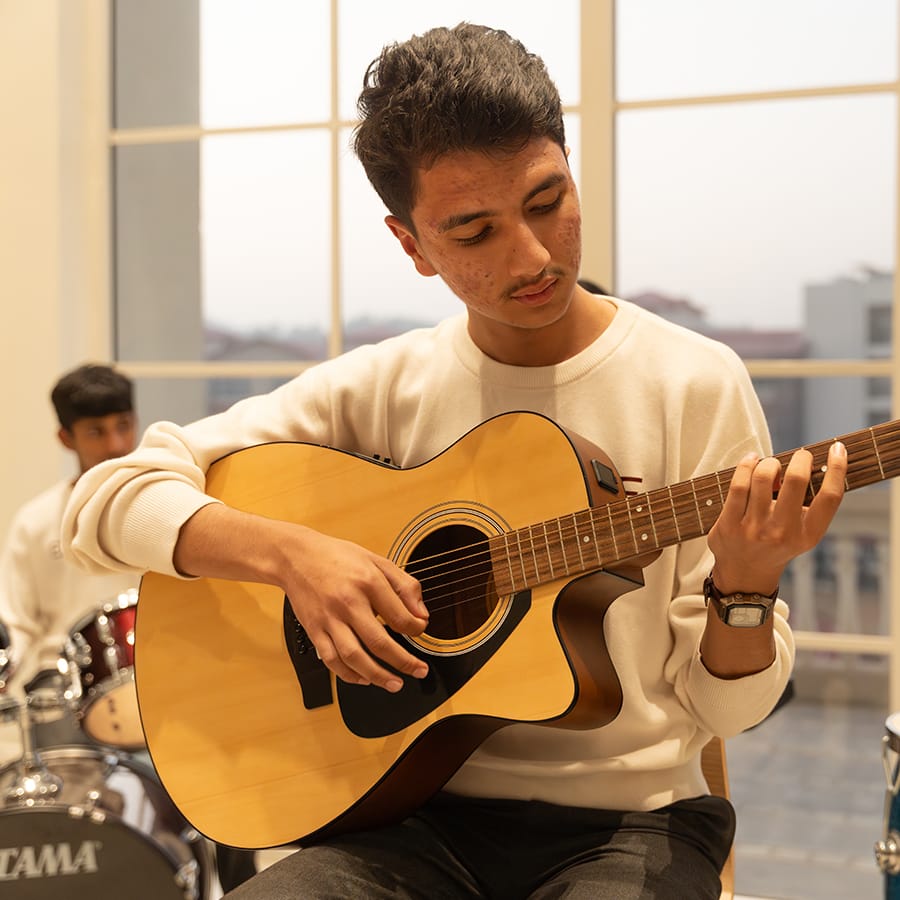 A student playing guitar